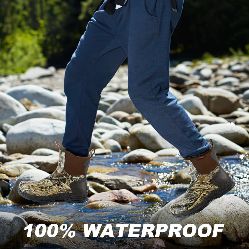Camouflage waterproof rain boots on rocks with water splash near the toe