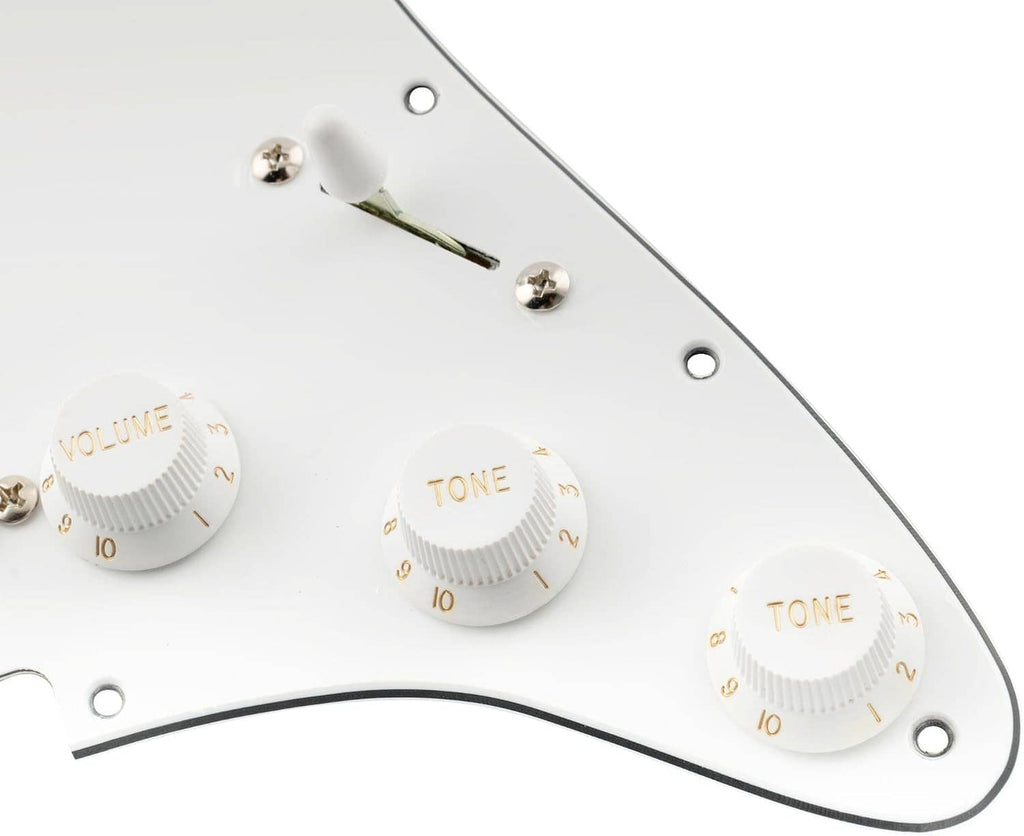 Close-up of white pickguard with volume and tone knobs and mounting screw holes