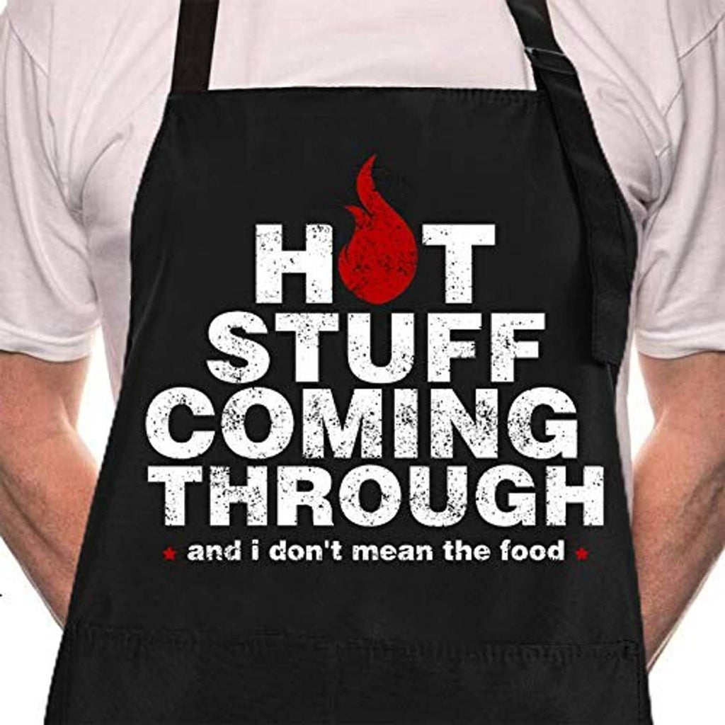 Black BBQ apron with “HOT STUFF COMING THROUGH” text, red flame icon, and footer line