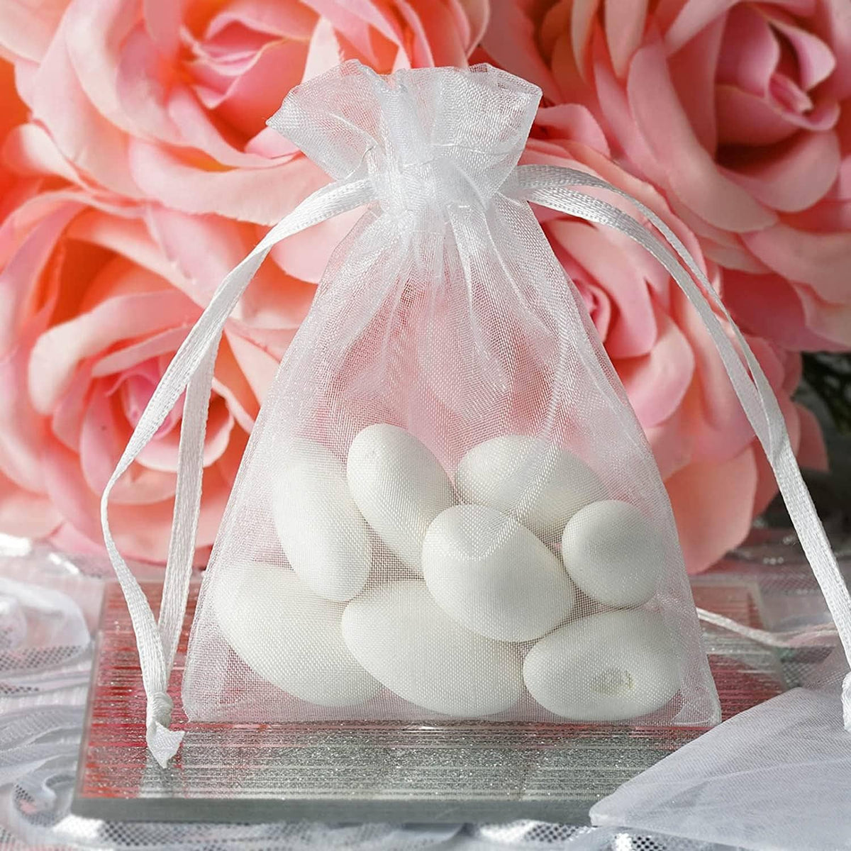 White organza drawstring bag filled with white heart-shaped candies