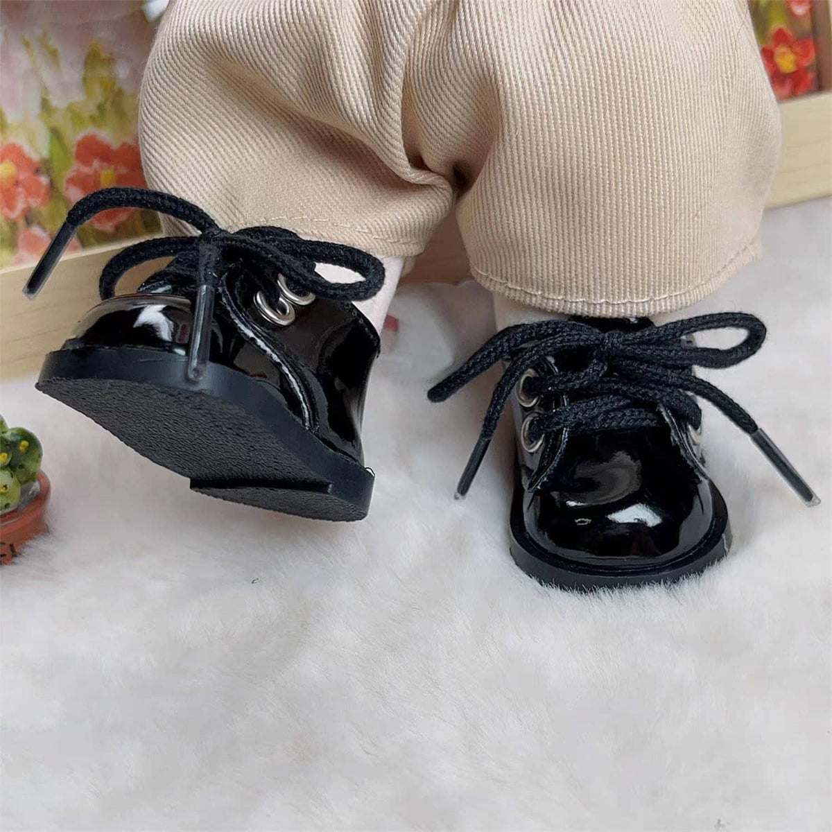 Black glossy mini lace-up doll shoes with thick sole and side strap detail