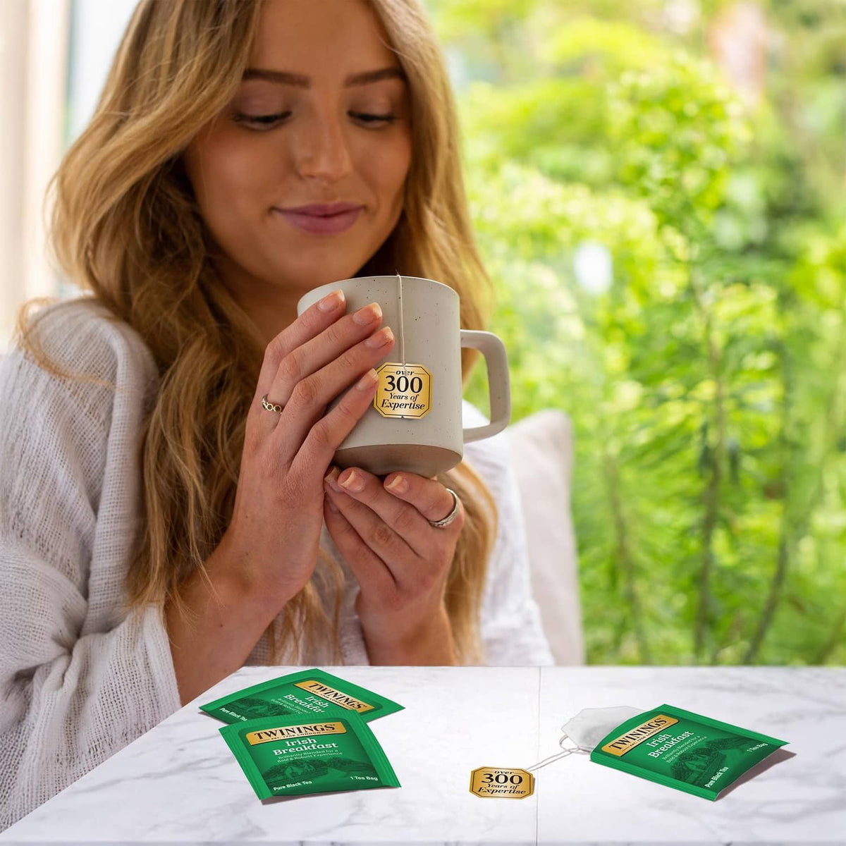Irish Breakfast tea with white mug and tea bag sachet packs on table