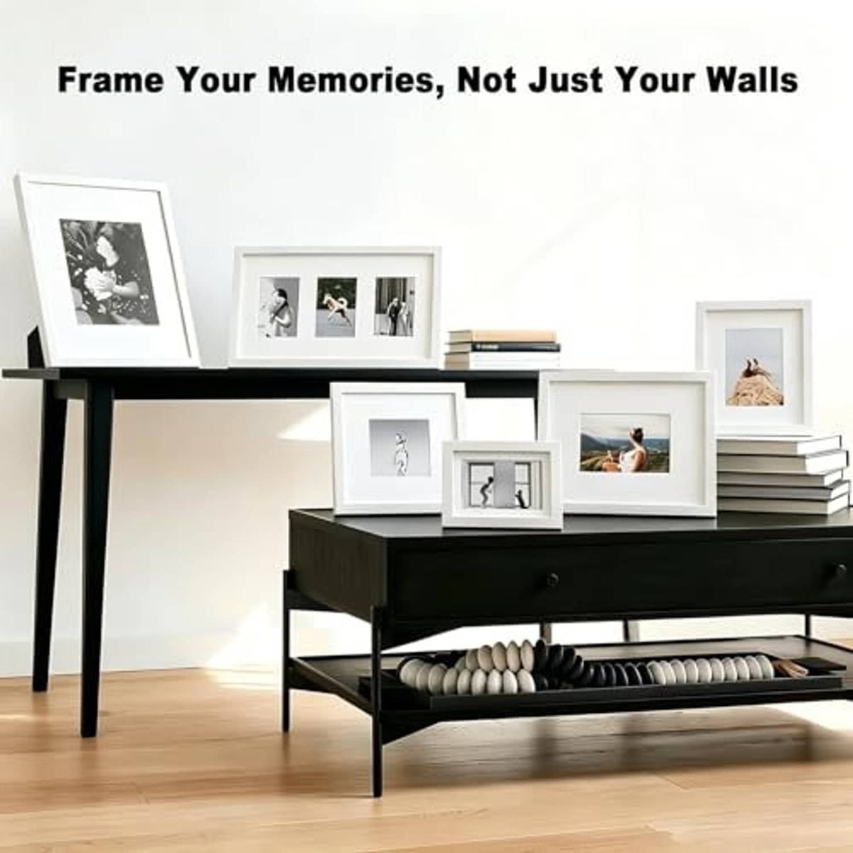 Set of white wooden picture frames displaying assorted photo prints on a console