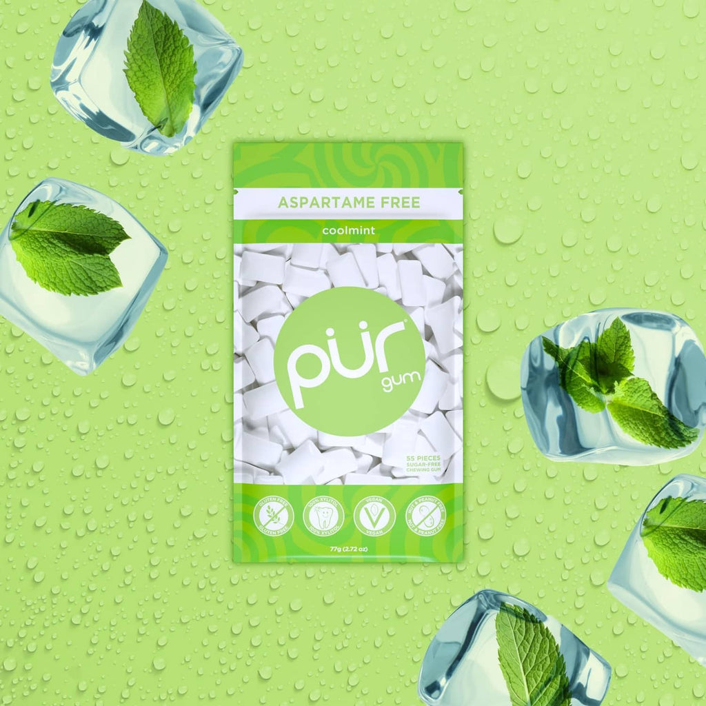 Coolmint xylitol gum pouch with white gum pieces and mint leaves