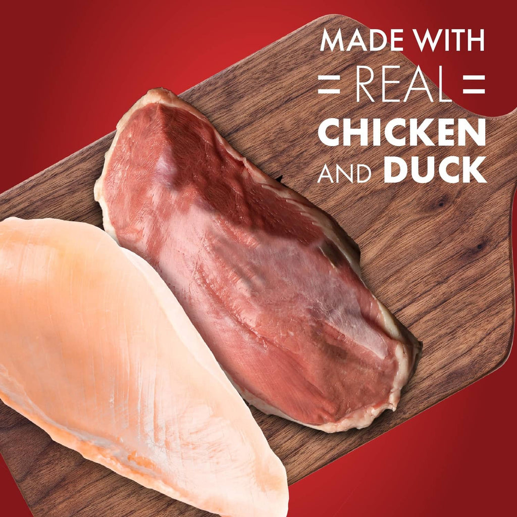 Two raw chicken and duck meat strips on a wooden board