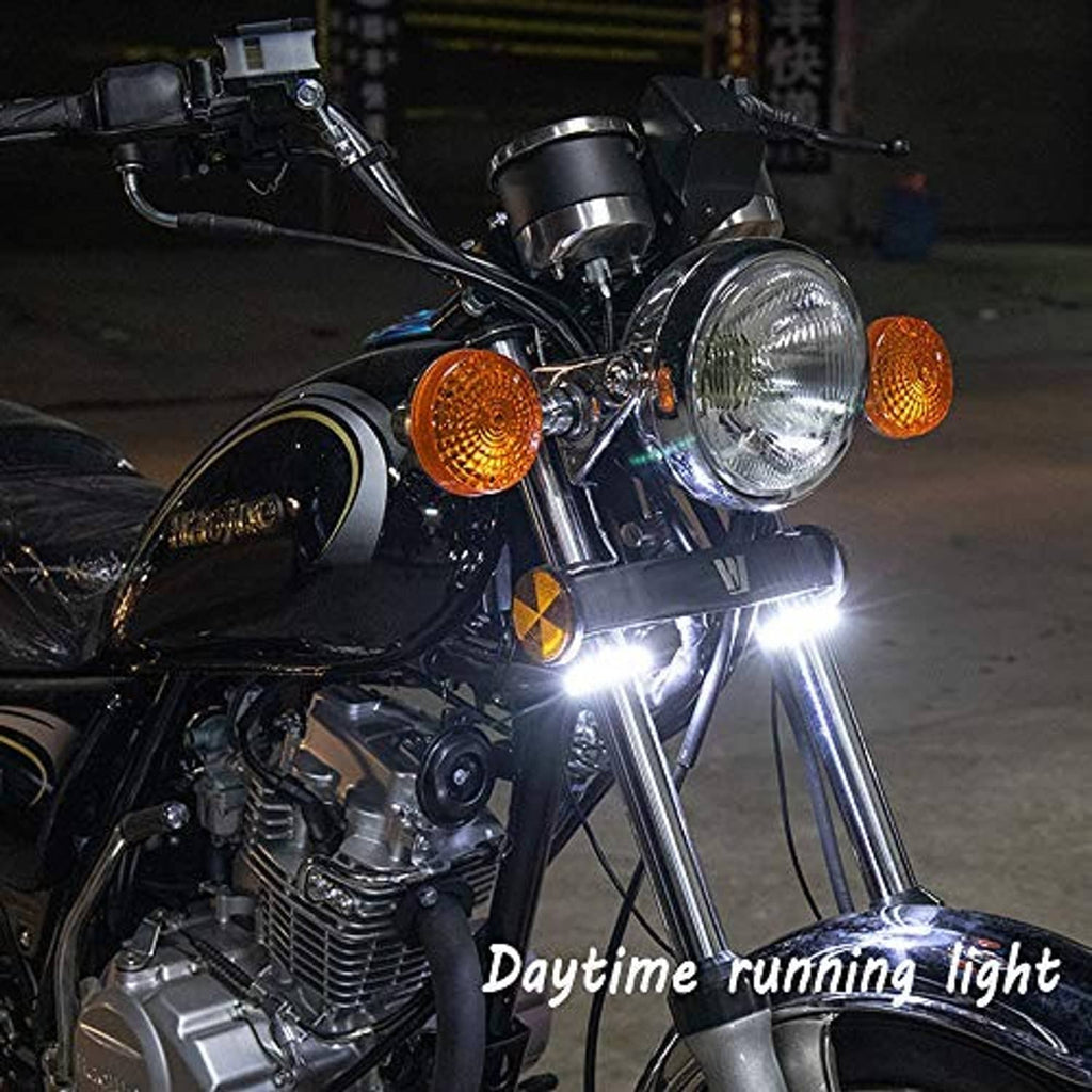 Motorcycle front with illuminated white daytime running light from LED fork signals