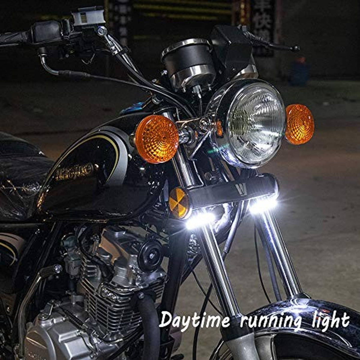 Motorcycle front with illuminated white daytime running light from LED fork signals