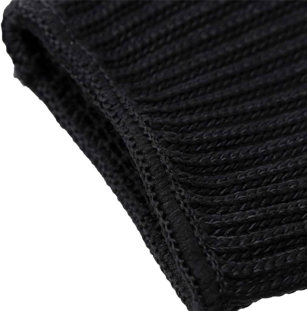 Black knit glove fabric seam detail with textured protective weave close-up