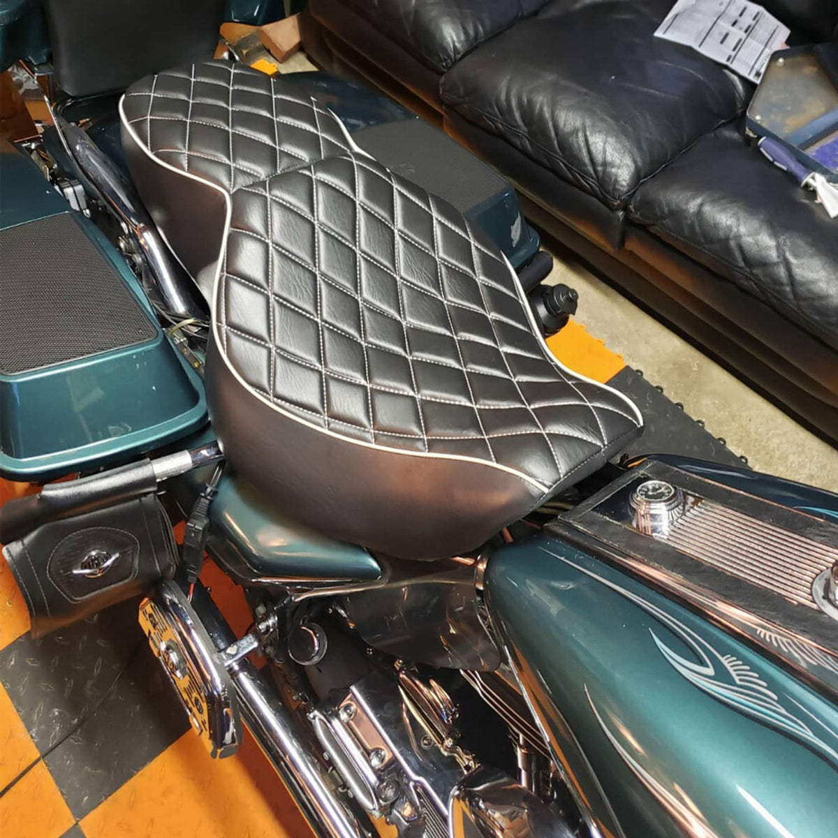 Two-up motorcycle passenger seat with black leather-look surface and diamond quilt stitching