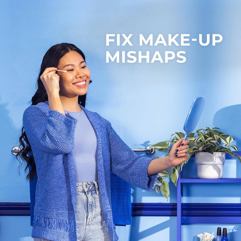 Cotton swab used for beauty touch-ups, with swab held near face