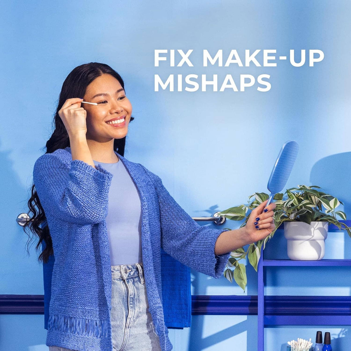 Cotton swab used for beauty touch-ups, with swab held near face