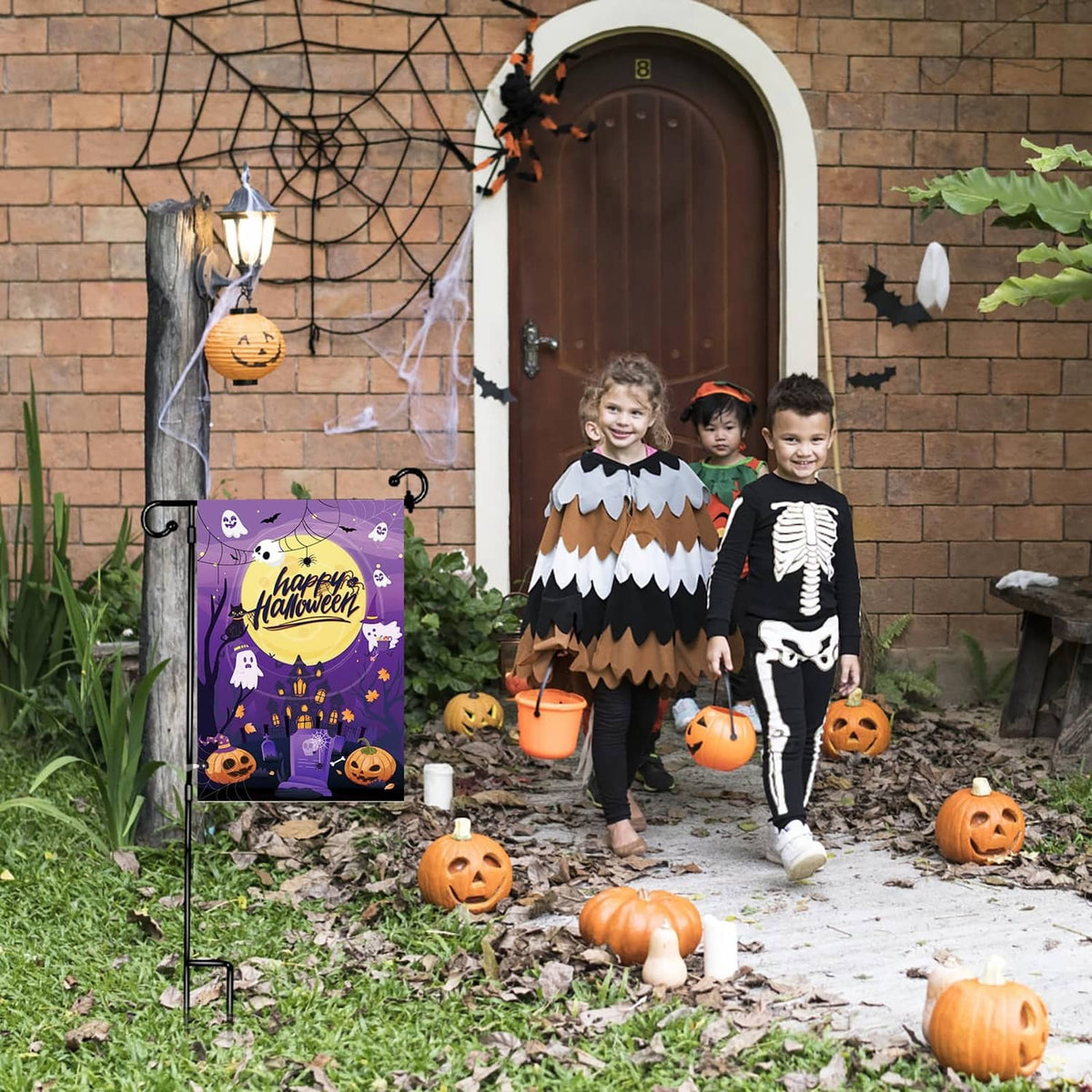 Black garden flag clips and stakes holding Halloween-style flags outdoors