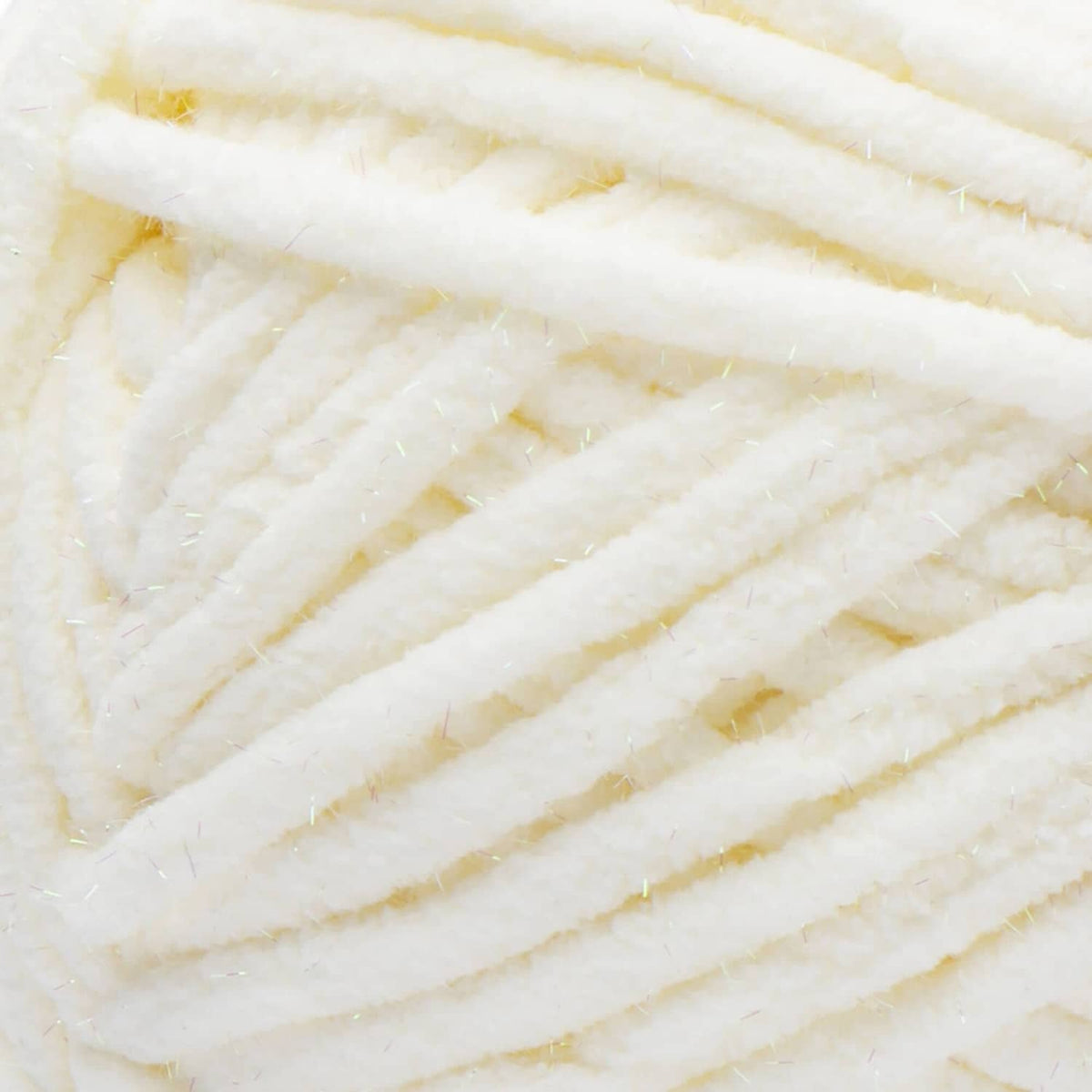 Cream super bulky yarn close-up with subtle gold sparkle fibers and plush texture