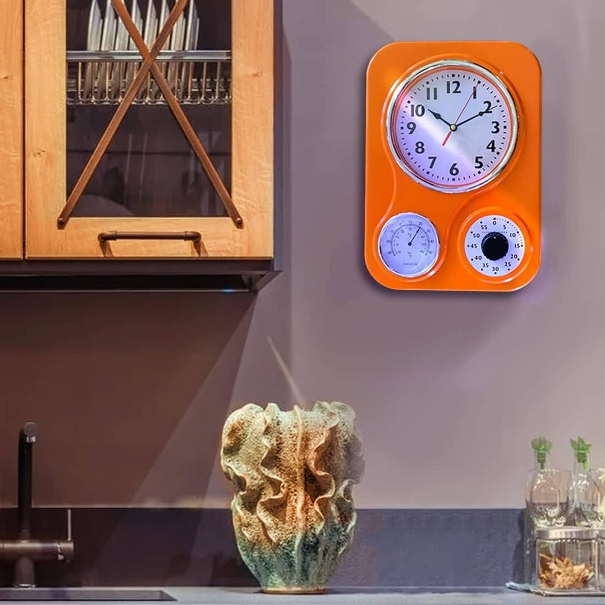 Orange retro kitchen wall clock with analog time and two small weather gauges