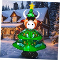 Inflatable highland cow figure in green Christmas tree dress with white horns and star topper