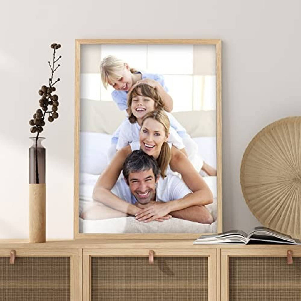 Light oak picture frame with white mat holding a family photo