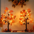 Lighted fall acorn tree decorations with orange leaf lights, two standing trees