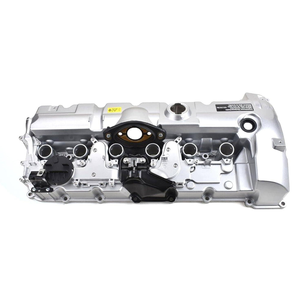 Aluminum engine valve cover with black ignition coil covers and sensor ports, front view