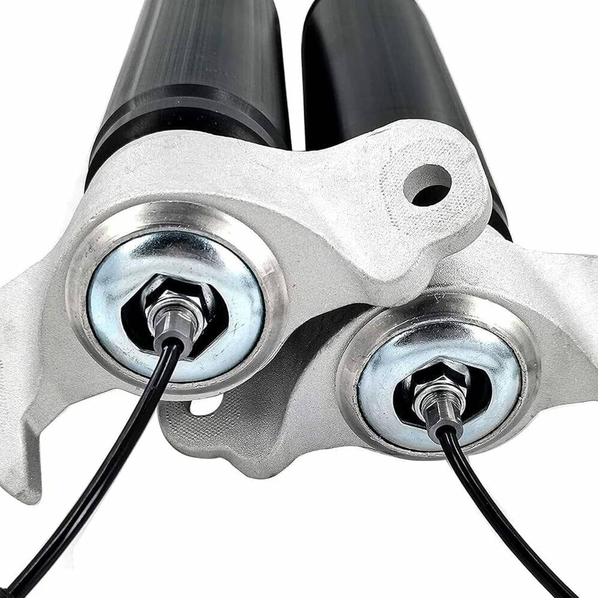 Shock strut upper brackets with silver plates, hex bolts, and black cable leads