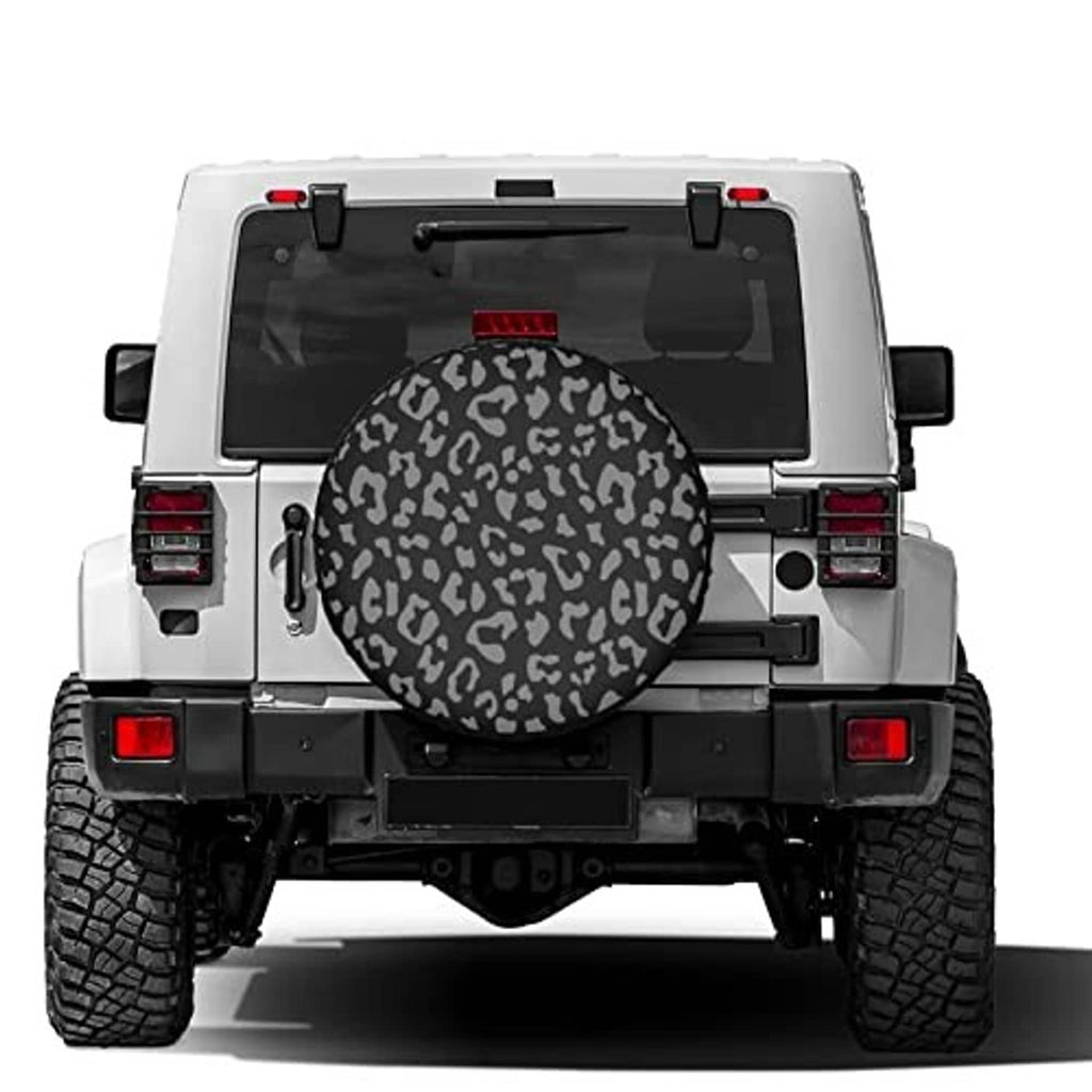 Spare tire cover on rear of SUV, leopard-print circular cover over swing-out mount