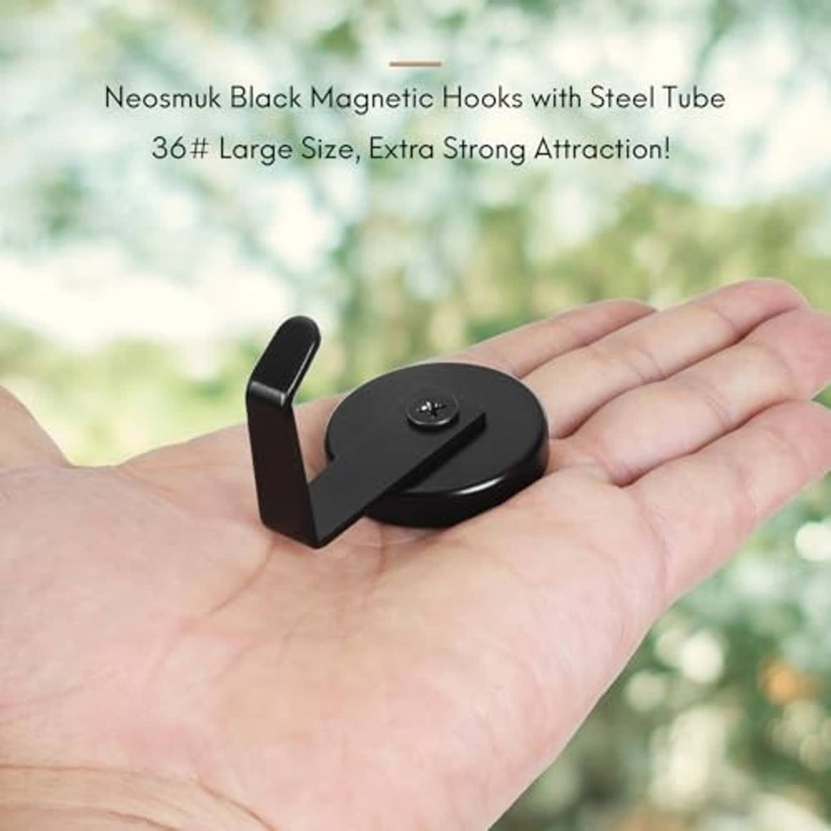 Black magnetic hook with circular magnet base and steel tube arm held in hand