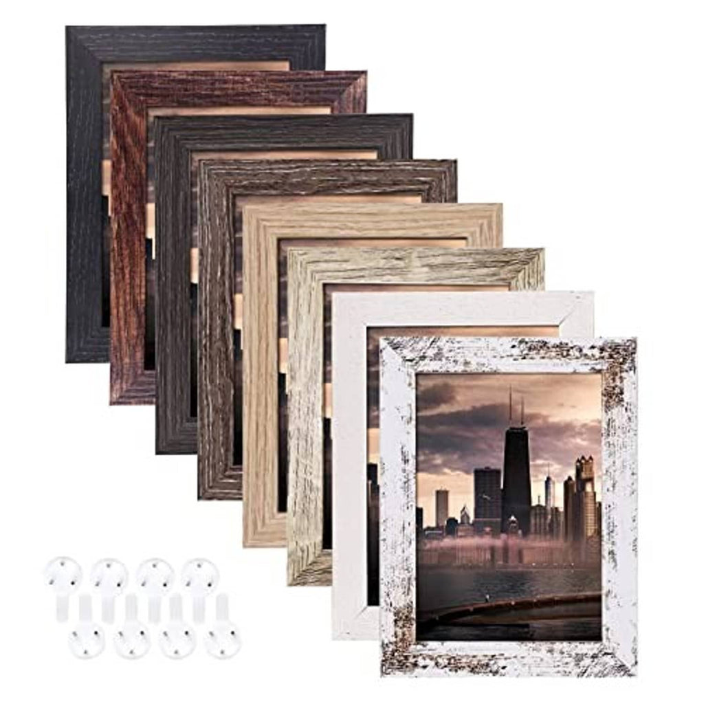 Cluster of small distressed wood photo frames with clear fronts and wall-hang clips
