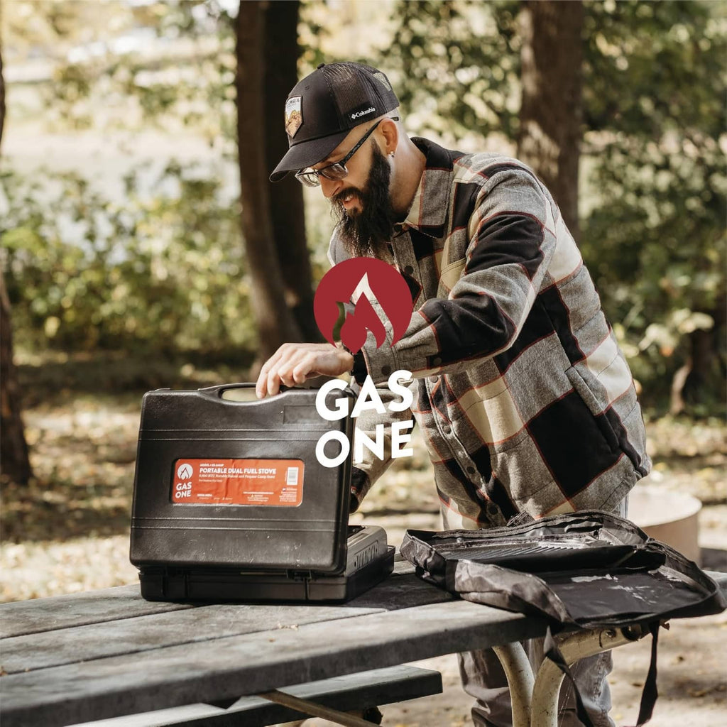 Portable dual-fuel stove with fuel canister and burner, beige compact design on table