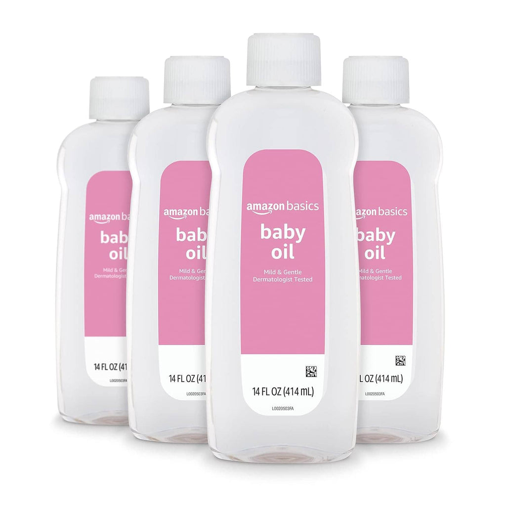 Multiple baby oil bottles with white caps and pink labels for dry-skin moisture protection