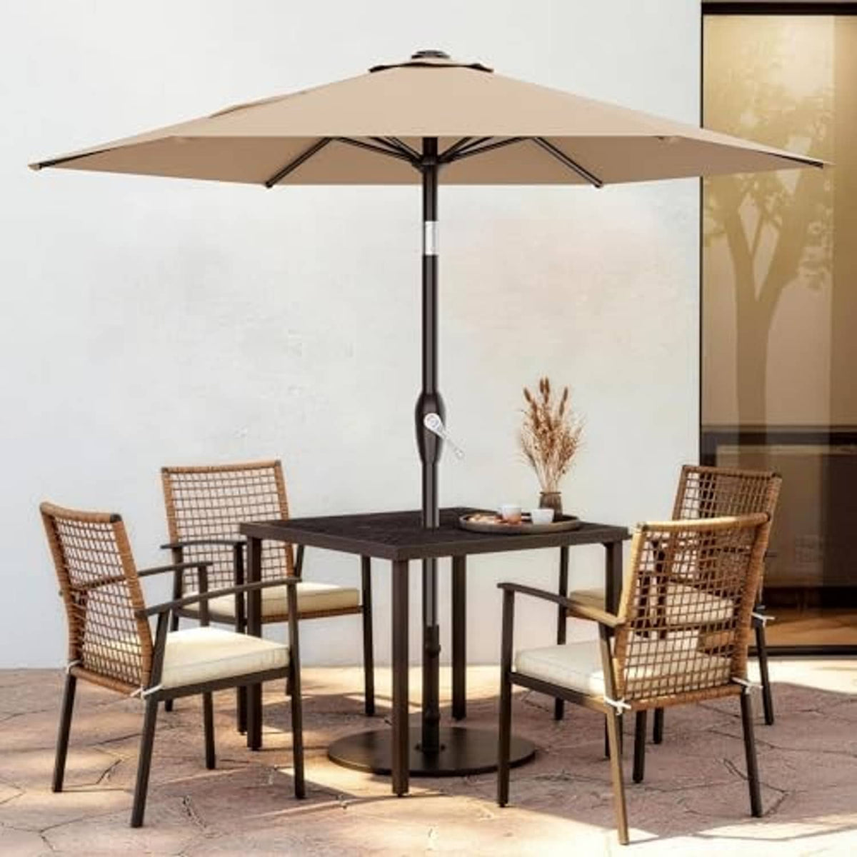 Beige patio market umbrella over outdoor dining table and four chairs