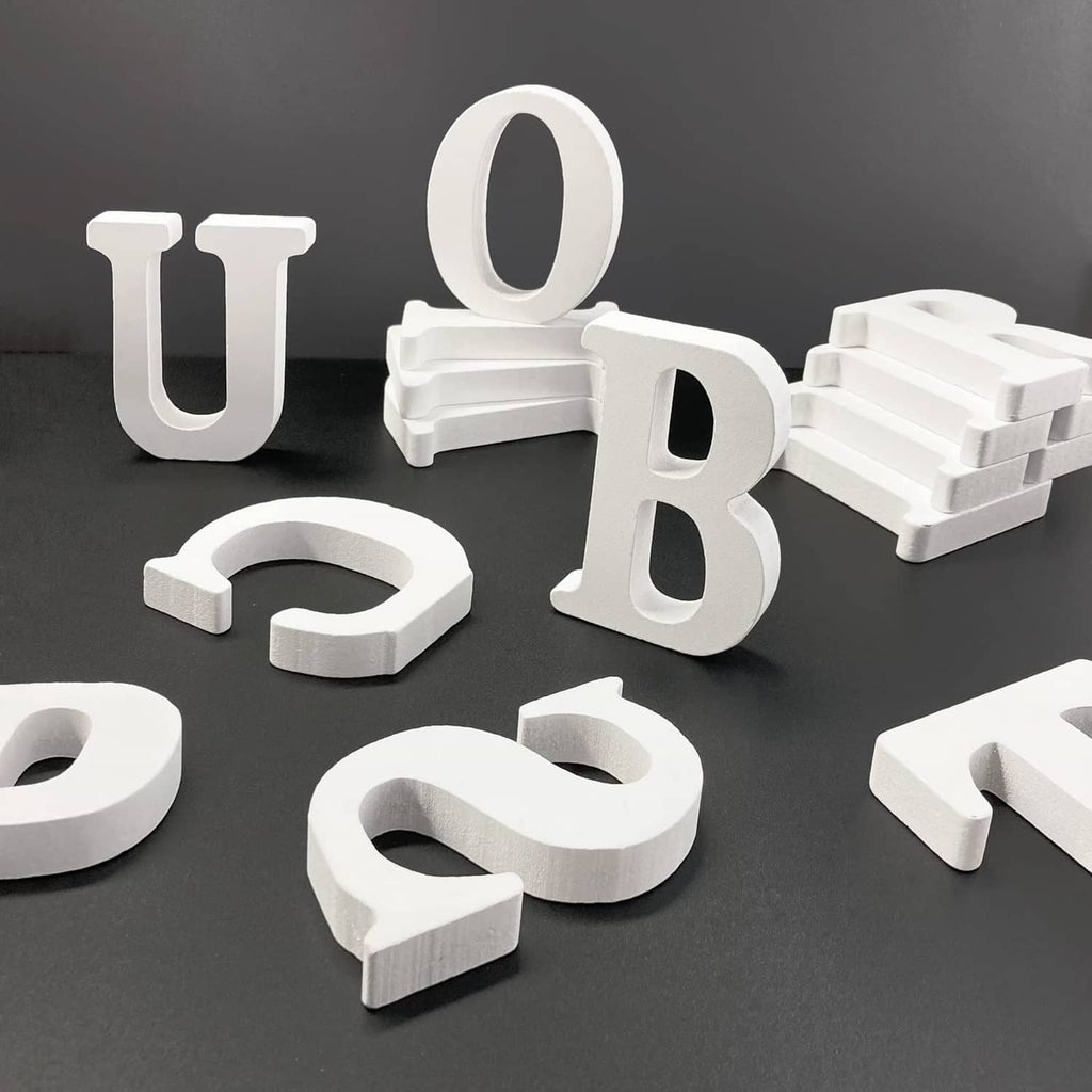 White unfinished wood marquee letters set with thick cutouts; letter O visible