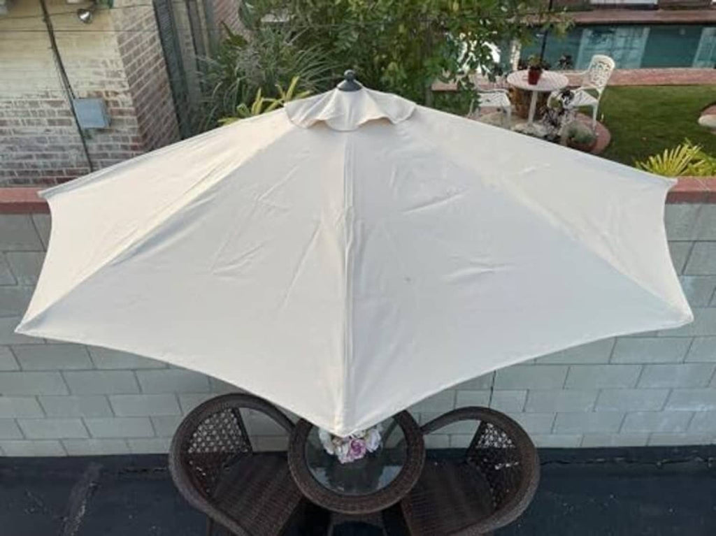 Light gray umbrella canopy over central pole with fabric seams and ribs