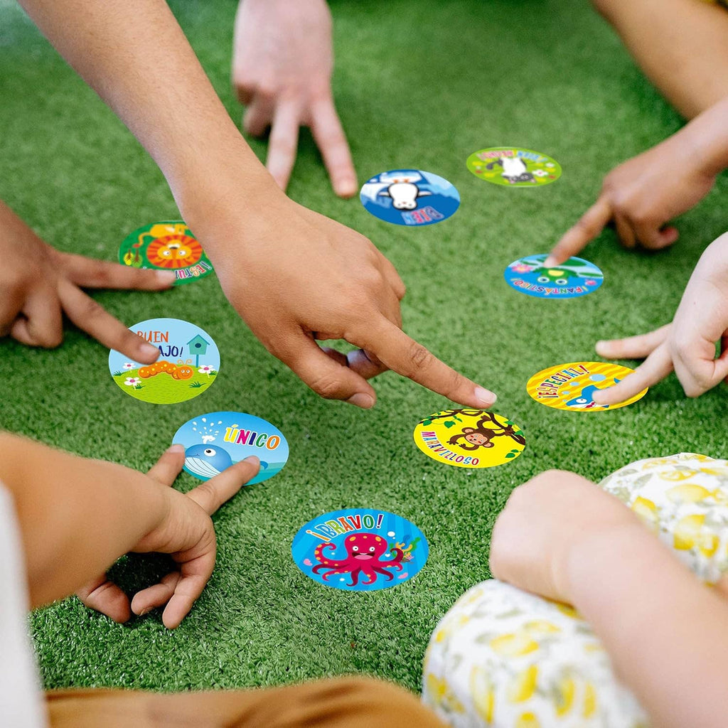 Children placing round Spanish teacher reward stickers on green grass for a game