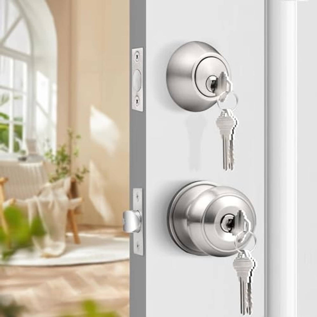 Brushed nickel deadbolt and door knob set with two keys on an entry door