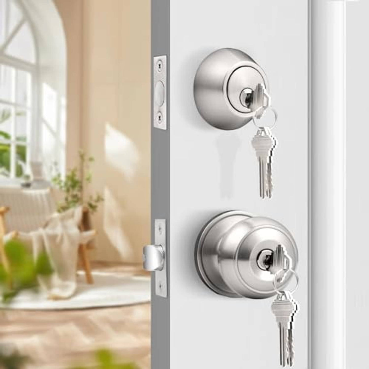 Brushed nickel deadbolt and door knob set with two keys on an entry door
