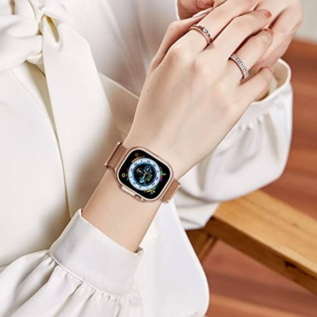 Rose gold metal magnetic watch band worn on wrist with adjustable mesh links