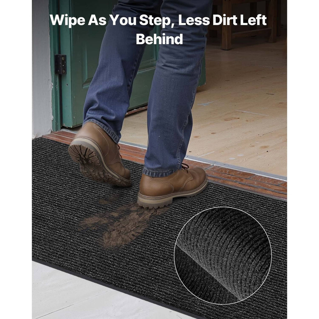 Dark textured door mat for wiping shoes, with ribbed pile surface