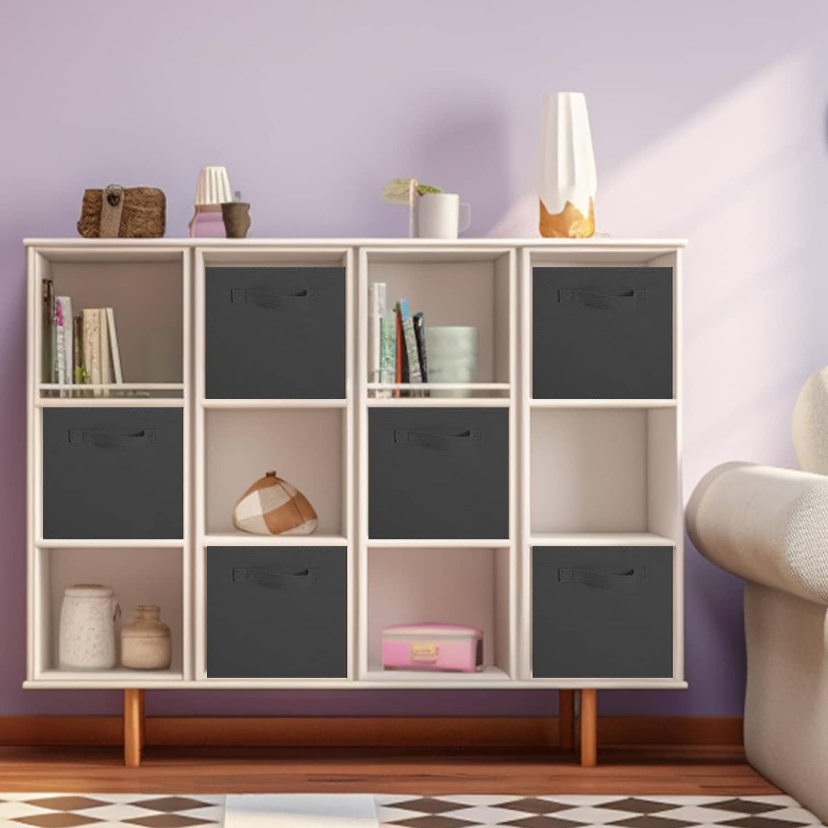 Black fabric storage cubes with front handles inside a cabinet grid