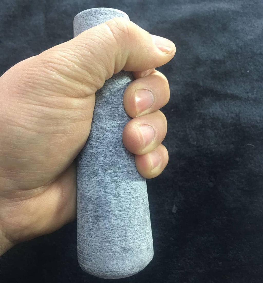 Gray granite pestle replacement held in hand