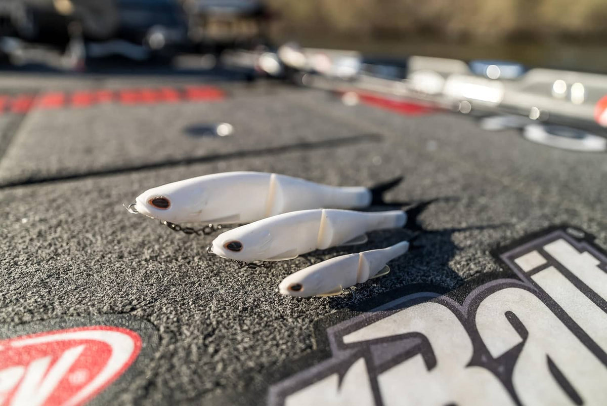 Three white soft plastic glide baits with black eyes and small fins
