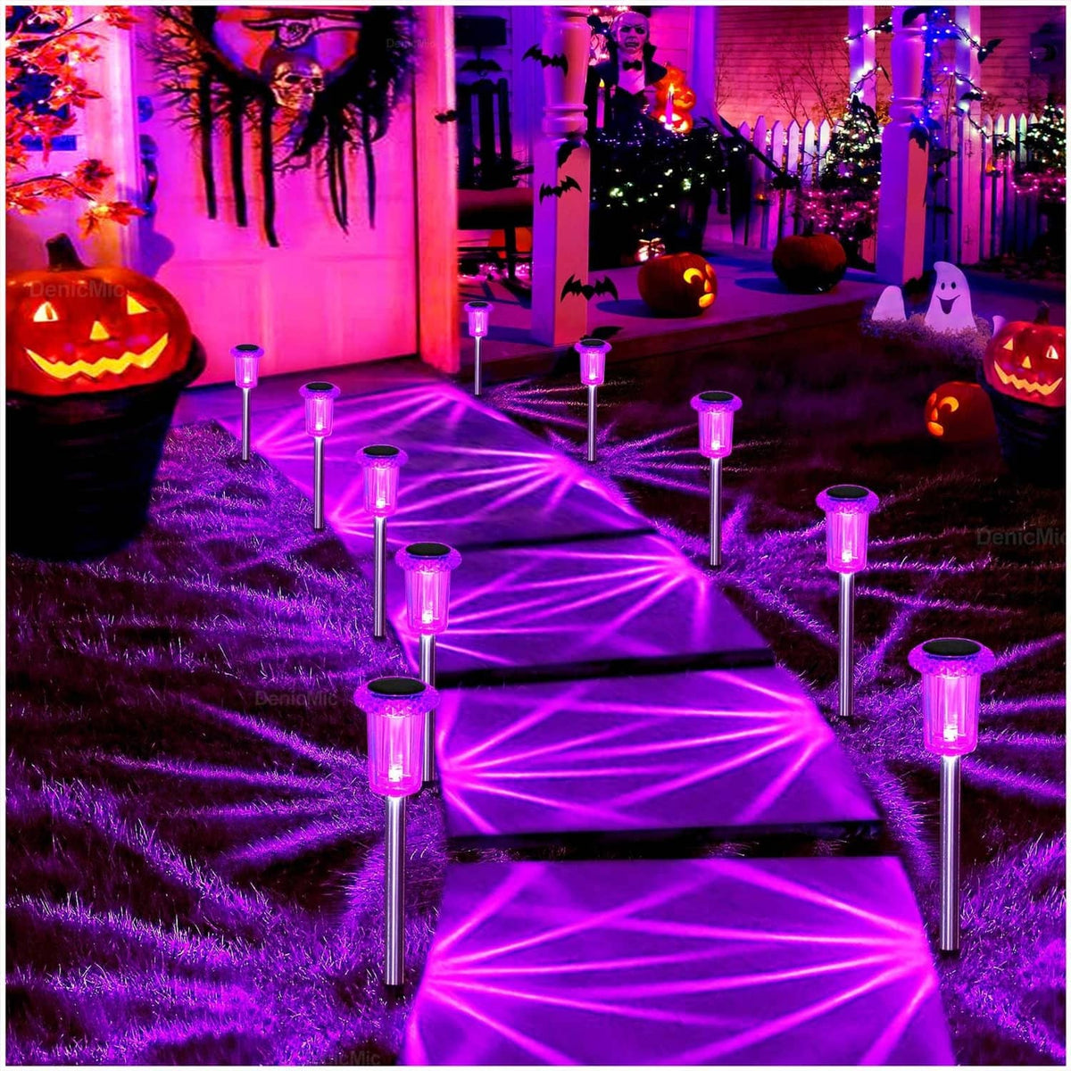 Purple solar pathway spike lights spaced along a walkway, glowing purple in a yard