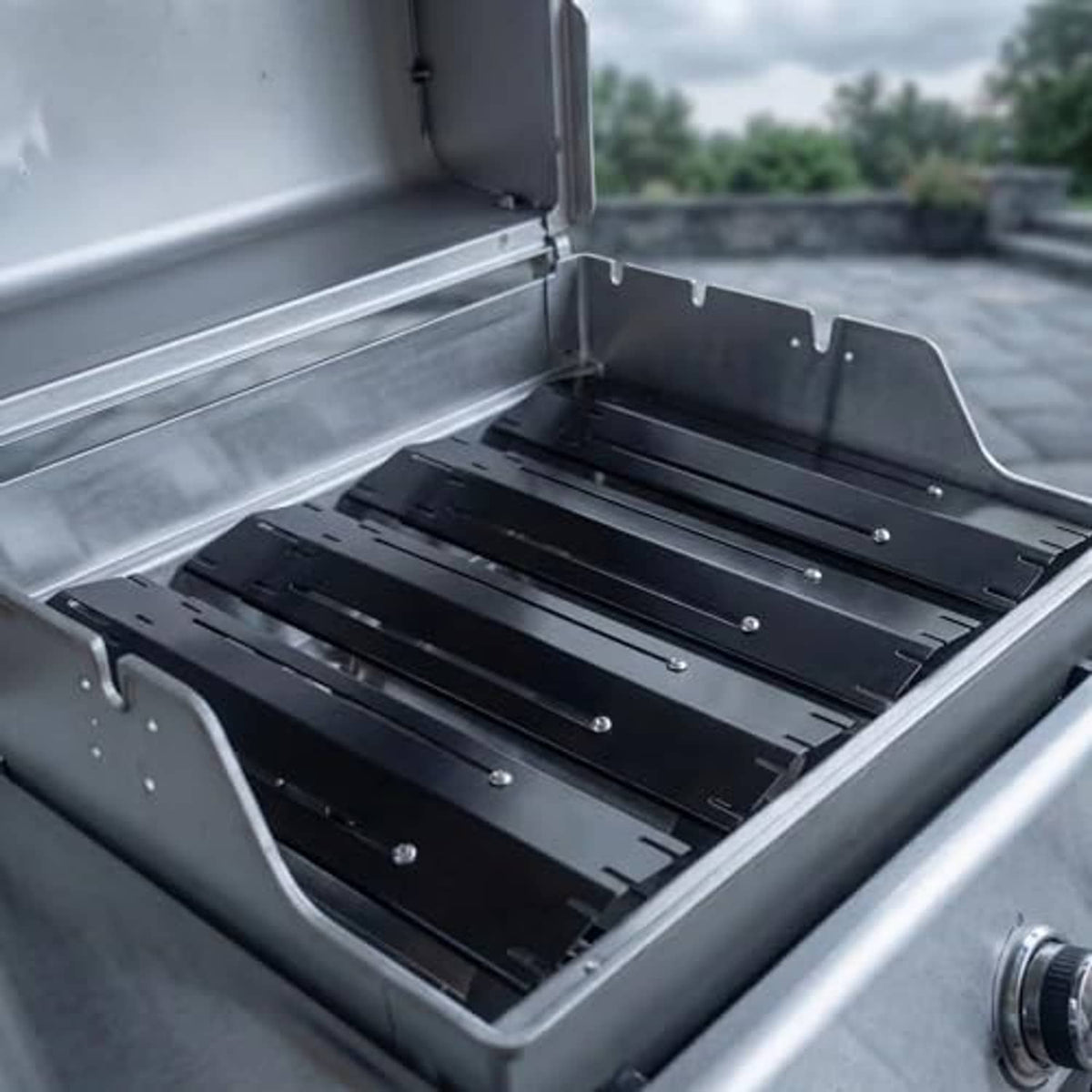 Universal grill heat shield plates installed inside grill box, dark steel with mounting points