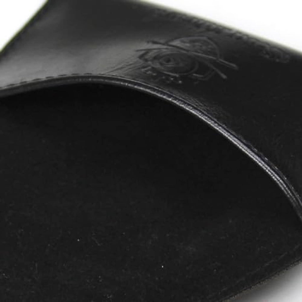 Embossed logo detail on black PU leather chalk holder pouch surface