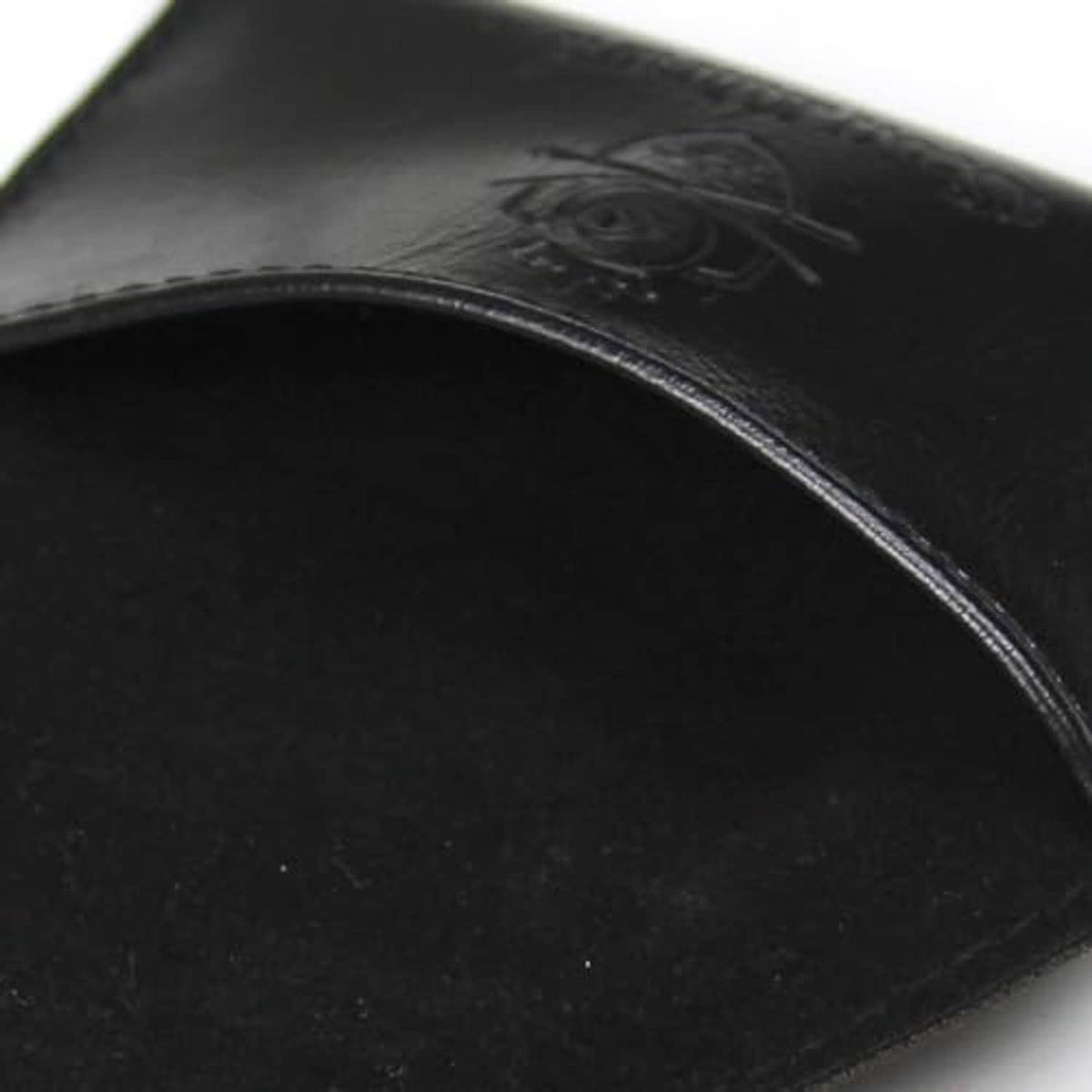 Embossed logo detail on black PU leather chalk holder pouch surface