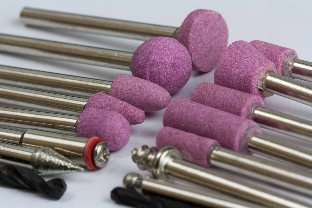Rotary tool sanding stones with purple abrasive sleeves on metal mandrels
