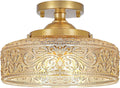 Gold semi-flush ceiling light with ornate patterned glass shade and round canopy