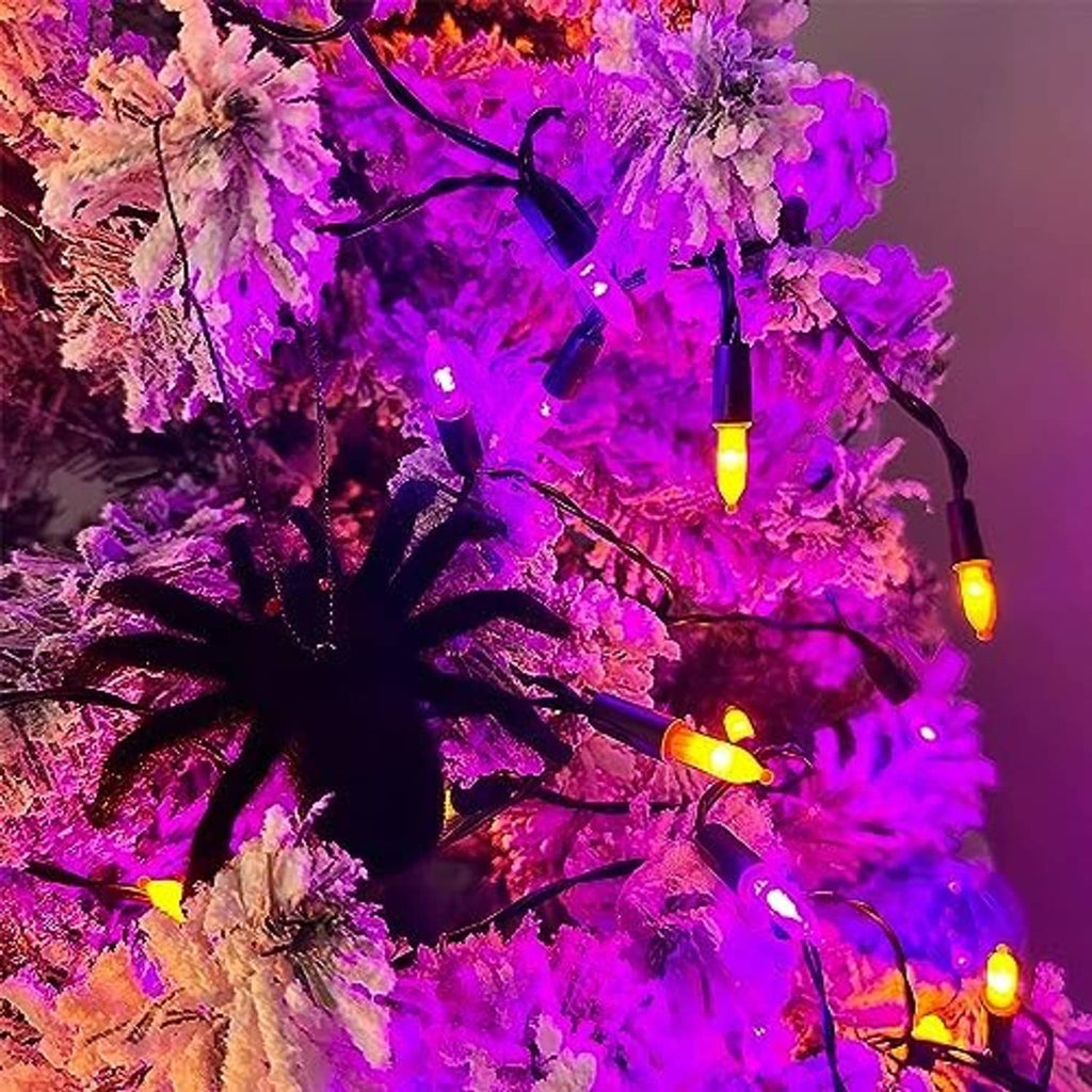Purple and orange mini LED string lights wrapped on tree branches