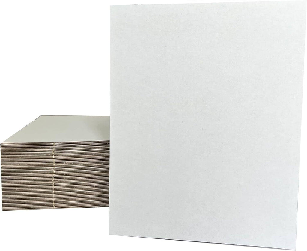 White cardboard sheets with corrugated backing, shown stacked