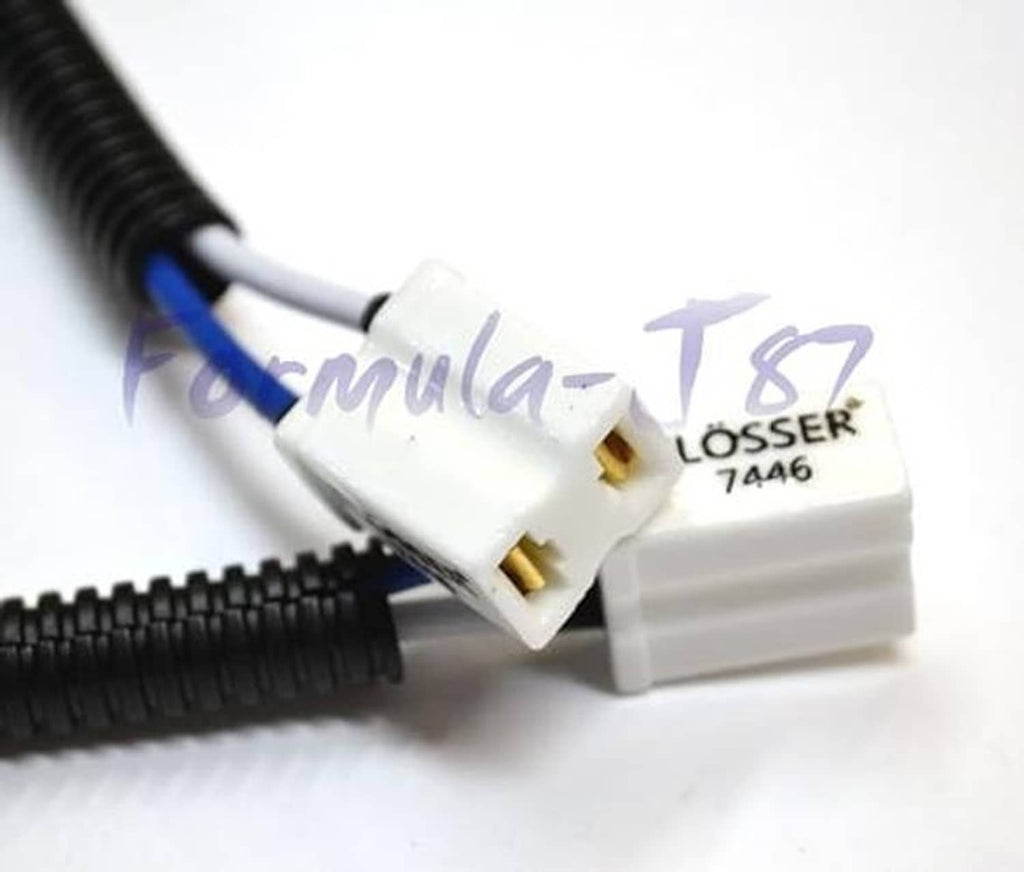 Close-up: white Flosser 7446 pigtail connector on black corrugated wire harness