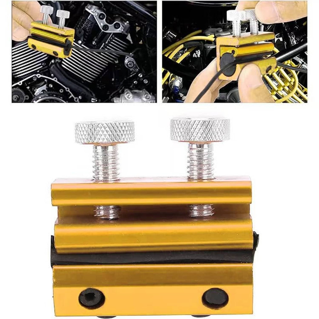 Gold cable lubrication tool with two knurled caps and dark rubber pads on the base.