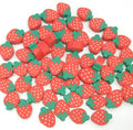 Strawberry-shaped polymer clay beads with red fruit and green leaf caps.